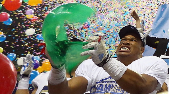 Kenny Young of the UCLA Bruins pops a balloon after a 40-35 win against the Kansas State Wildcats at Alamodome in San Antonio, Texas