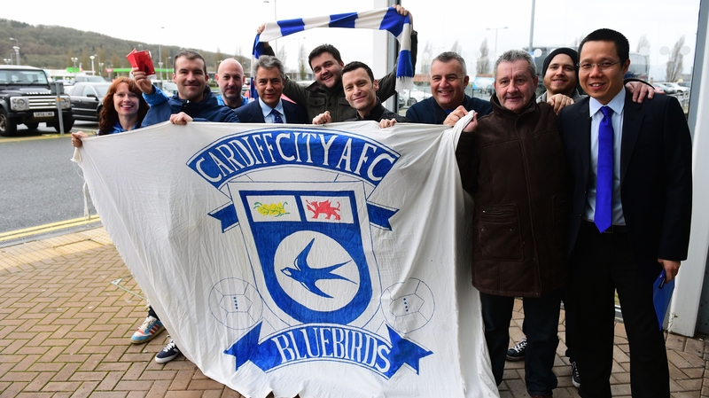 Cardiff City fans pose with chairman Mehmet Dalman and chief executive Ken Choo after it was announced that the club would revert to their blue home kit