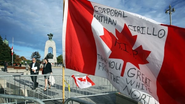 A commemorative flag near the War Memorial in Ottawa where a ceremonial guard was shot and killed by a gunman in October