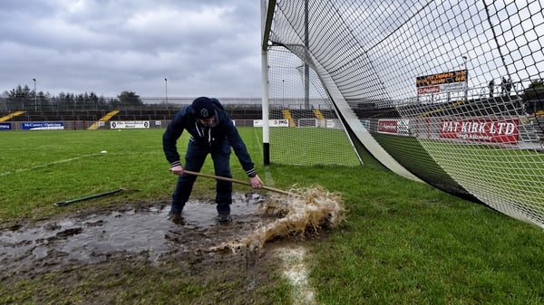 Groundsman Paul Turbett tries to clear the goalmouth ahead of the Tyrone vs St Mary's McKenna Cup game