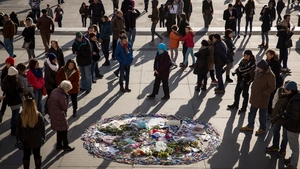 People gather in Trafalgar Square, London to show their respect to victims of the terrorist attacks in Paris