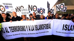 Muslims in Madrid hold banners reading 'No to terrorism and to Islamophobia ' and 'Islam = Peace'