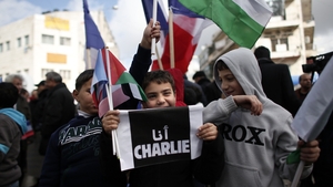 A Palestinian child holds a placard reading in Arabic 'I am Charlie' in the centre of the West Bank city of Ramallah
