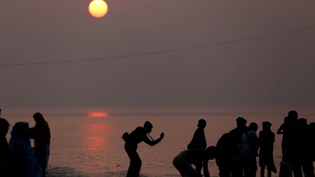 Devotees perform rituals in the Bay of Bengal as they visit Sagar Island during the Gangasagar Fair, Eastern India