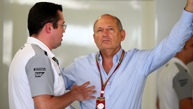 McLaren Racing Director Eric Boullier (L) speaks with Ron Dennis during the Japanese Formula One Grand Prix at Suzuka Circuit last year