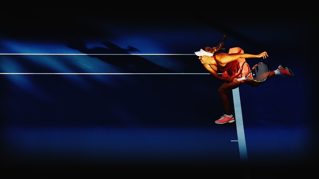 Caroline Wozniacki serves against Julia Glushko of Israel during day two of the 2015 ASB Classic at ASB Tennis Centre in Auckland