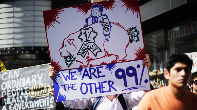 Protesters hold signs as they march to LA City Hall during a 2011 'Occupy Los Angeles' demonstration