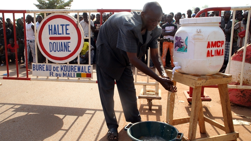 A man washes his hands in the village of Kouremale near the border with Guinea in November