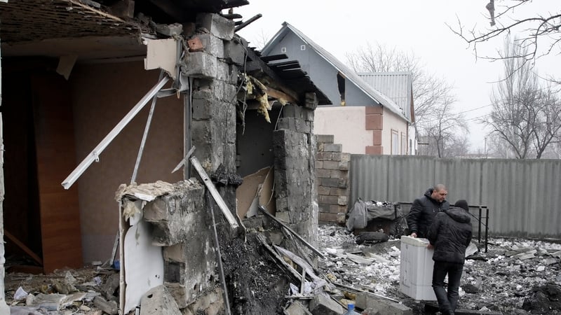 Locals search the remains of their homes which were reportedly damaged by shelling in Donetsk