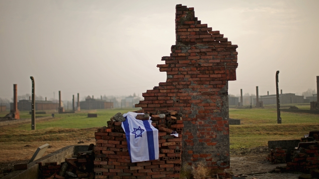 An Israeli flag lies on the ruin of a detention block at the Auschwitz II Birkenau