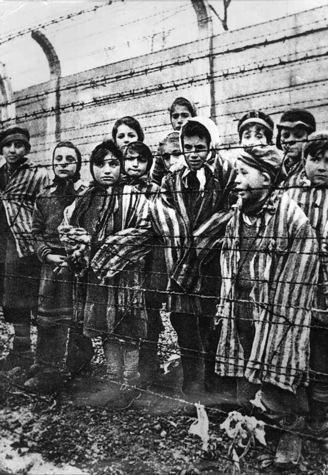 Children wear the camp uniform in this image from 1944