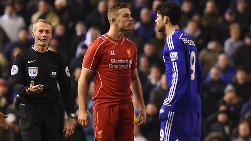 Liverpool's Jordan Henderson confronts Chelsea's Diego Costa