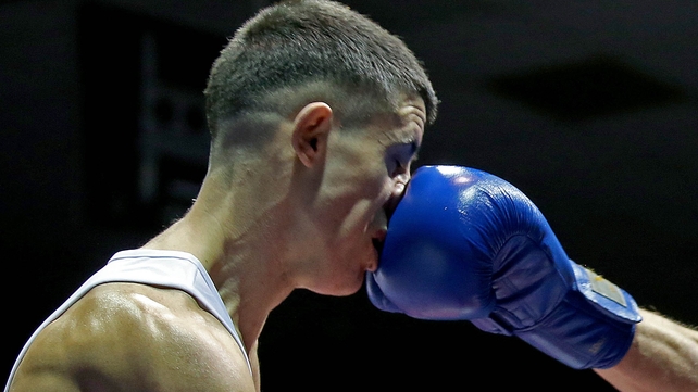 Adam Courtney takes a punch to the face during the National Senior Elite Championships at the National Stadium