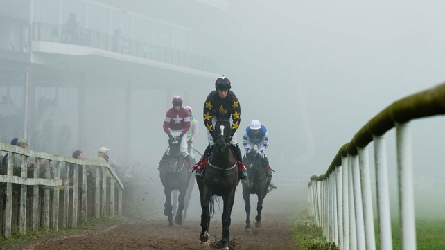 Runners and riders return to the parade ring on a foggy day at Gowran Park