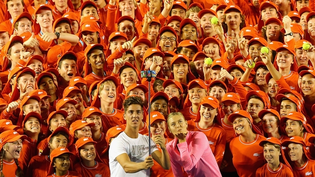 Thanasi Kokkinakis and Maria Sharapova pose with ball kids ahead of the Australian Open in Melbourne