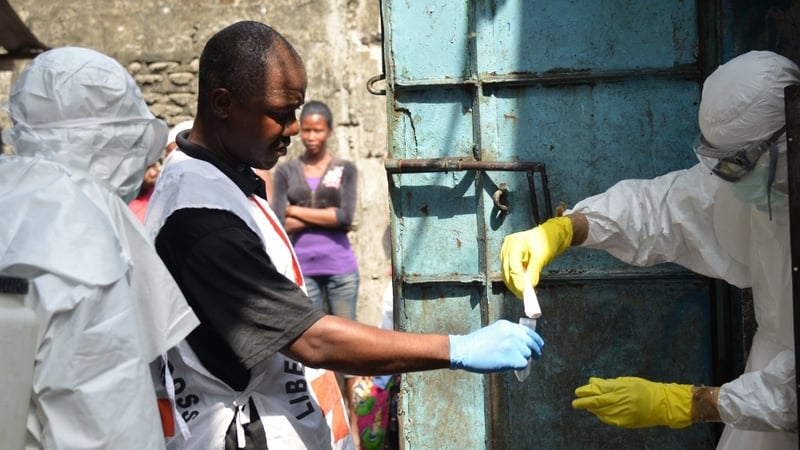 Red Cross workers in protective suits in Monrovia