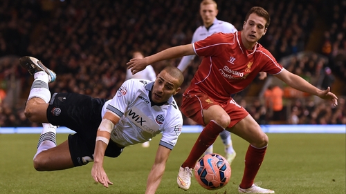 Darren Pratley of Bolton takes a tumble under a challenge from Javier Manquillo
