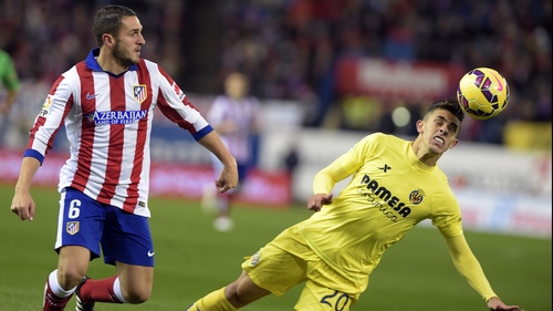 Gabriel Paulista (R) makes a clearance against Atletico Madrid
