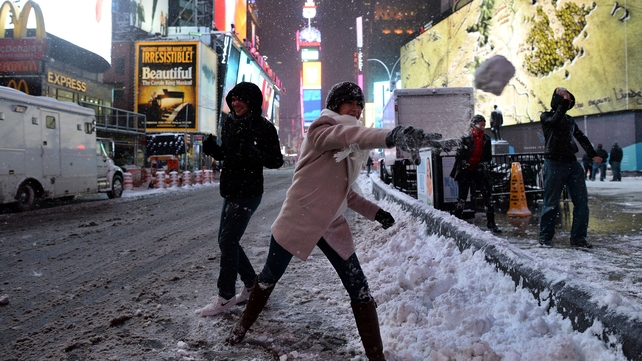 People take part in a snowball fight in New York's Times Square