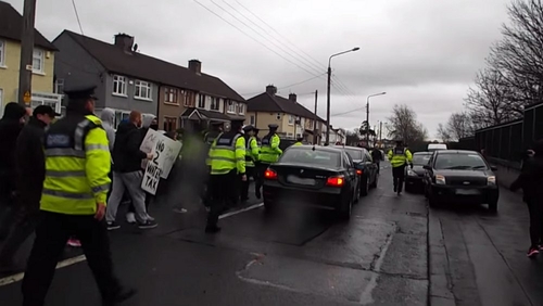 The President was heckled when he arrived and left Coláiste Eoin last Friday