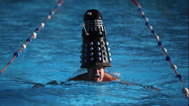 A Dalek takes a dip with a hardy competitior at the sixth UK Cold Water Swimming Championships at Tooting Bec Lido in London