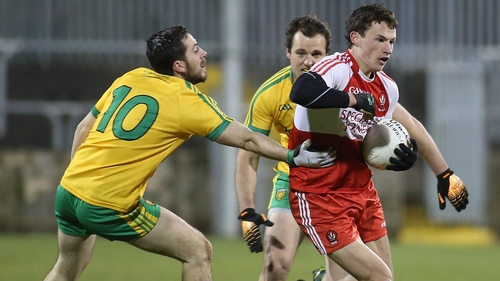 Derry's Kevin Johnston evades Donegal pair Mark McHugh and Michael Murphy