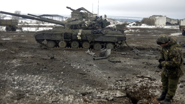 A Ukrainian soldier examines a crater after recent shelling near Debaltseve, in the Donetsk