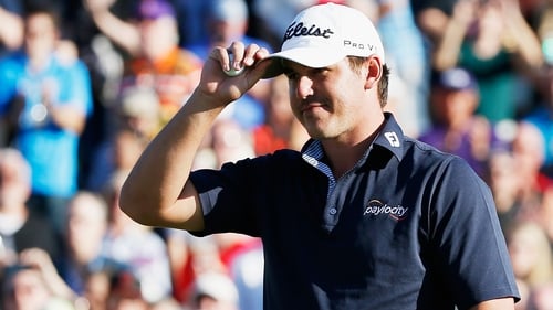 Brooks Koepka acknowldeges the gallery on the 18th green after winning the Waste Management Phoenix Open