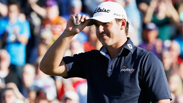 Brooks Koepka acknowldeges the gallery on the 18th green after winning the Waste Management Phoenix Open