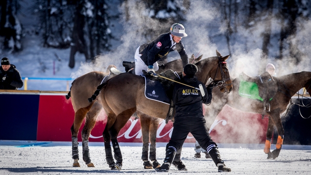 A member of the 'Badrutts Palace Hotel' team changes horse during the Snow Polo World Cup 2015 in St Moritz, Switzerland on Sunday