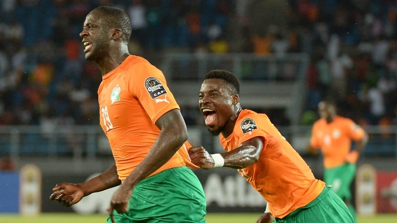 Yaya Toure celebrates with Serge Aurier (R) after scoring