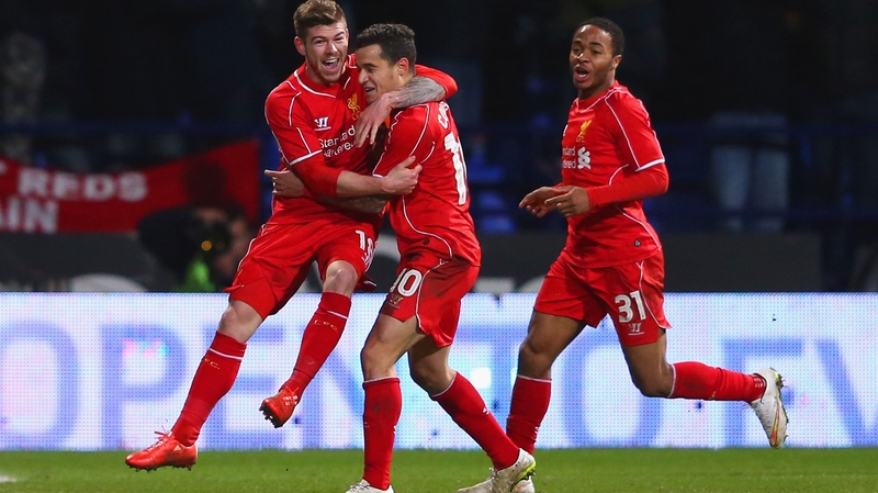 Philippe Coutinho celebrates scoring Liverpool's winner against Bolton with Alberto Moreno and Raheem Sterling