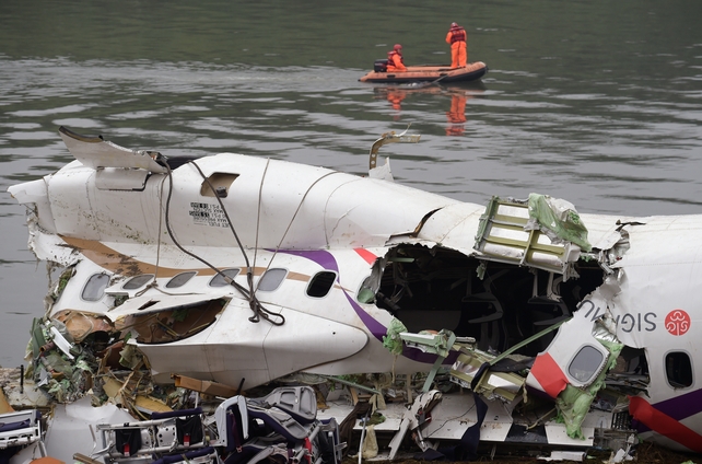 The fuselage lies on the river bank