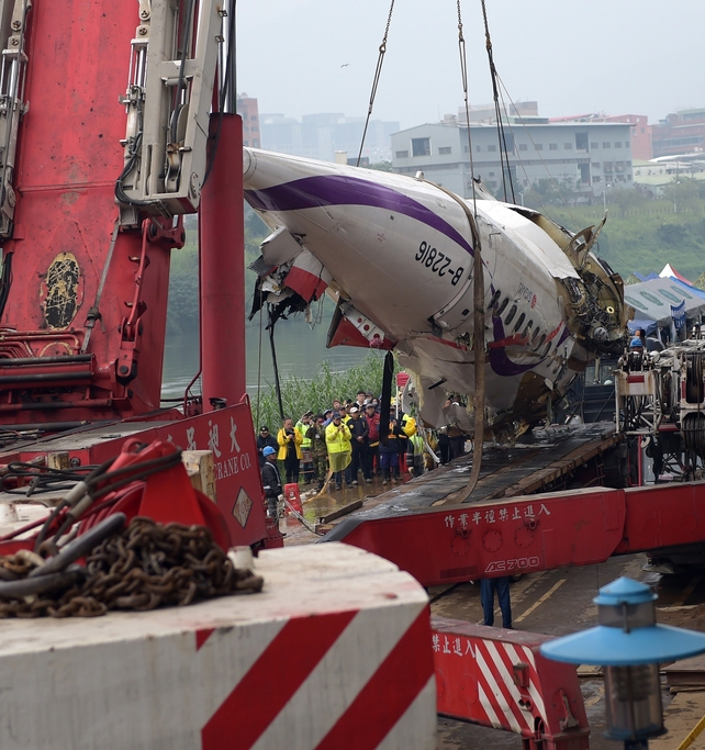 Part of the wreckage is raised from the water