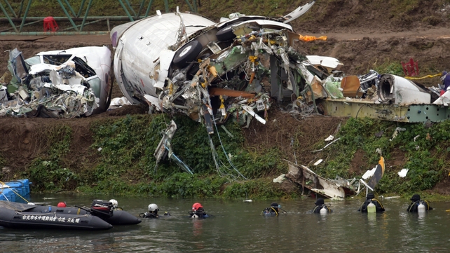 Teams search the water around the crash site