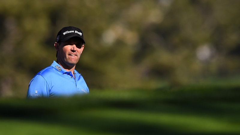 Padraig Harrington watches his chip out of the bunker on the 10th