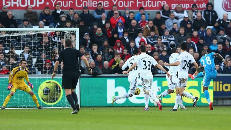 Jermain Defoe of Sunderland scores the opening goal at Swansea