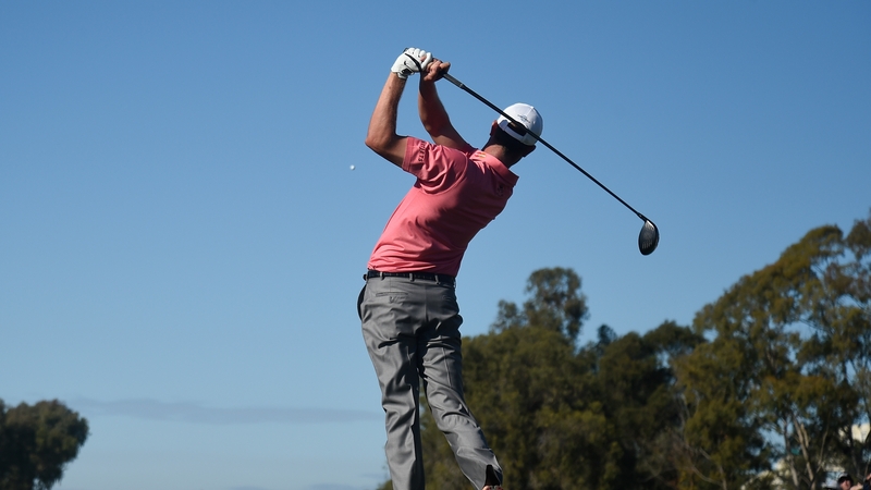 Harris English plays his tee shot on the 18th hole