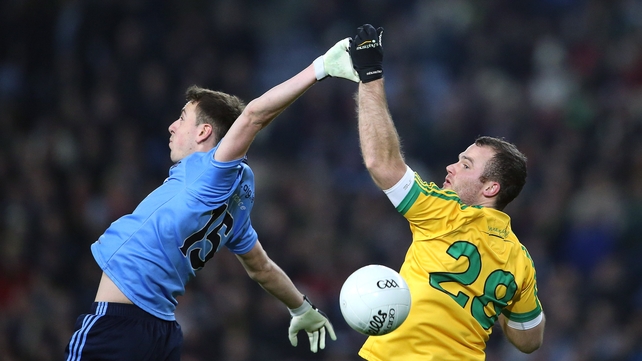 Dublin's Cormac Costello and Neil McGee of Donegal contest a high ball during the game on Saturday night
