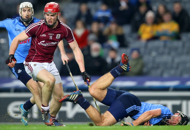 Dublin's Shane Durkin takes a tumble as Galway's Jonathan Glynn carries on