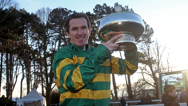 Tony McCoy poses with the Irish Hennessy Gold Cup after Carlingford Lough's victory