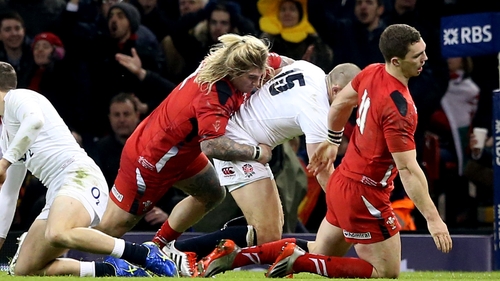 Wales' George North falls to the ground injured following a collision with his team-mate Richard Hibbard in Wales' game against England