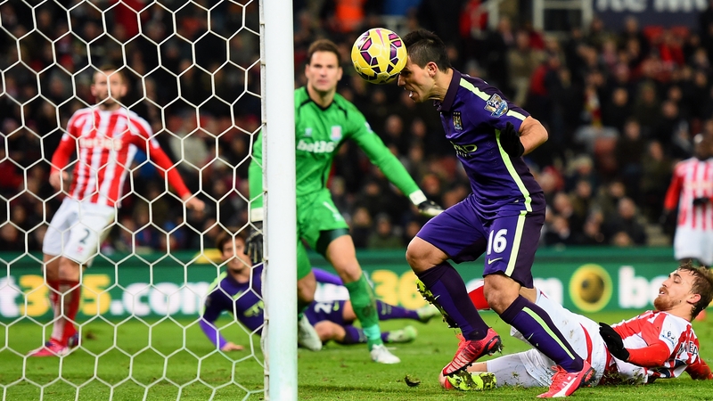 Sergio Aguero heads the ball towards goal before handling it across the line