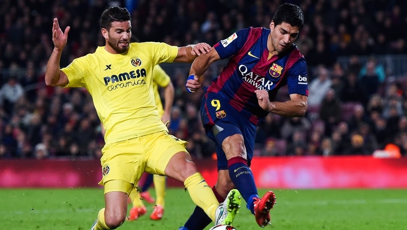 Luis Suarez of FC Barcelona competes for the ball with Mateo Musacchio of Villarreal