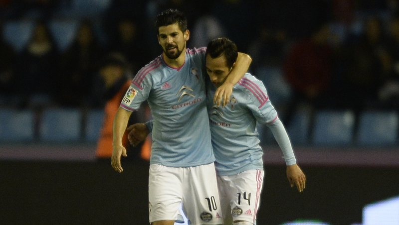Celta's Chilean forward Fabian Orellana (R) is congratulated by teammate forward Nolito after scoring