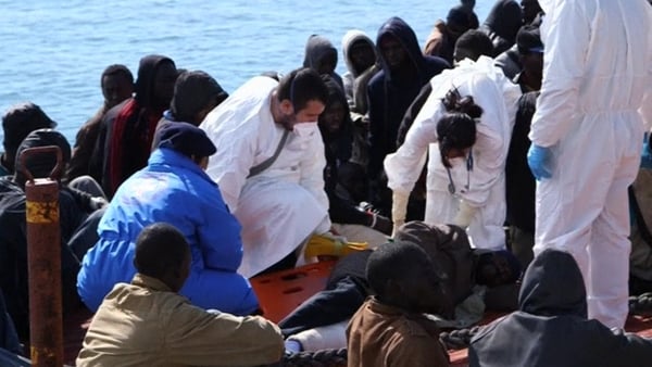 Some of the migrants receive help after arriving in Sicily