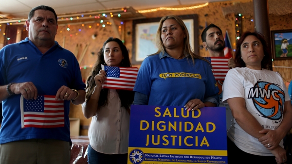 People stand together as they hold a press conference to protest the decision