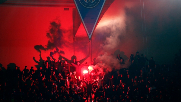 Chelsea fans light flares during their UEFA Champions League round of 16 first leg soccer match against Paris Saint Germain