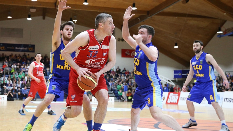 UCD Marian's Daniel James and Michael Chubb put pressure on Colin O'Reilly of C&S UCC Demons