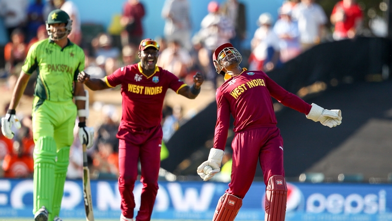 Denesh Ramdin (r) celebrates holding a catch in Christchurch